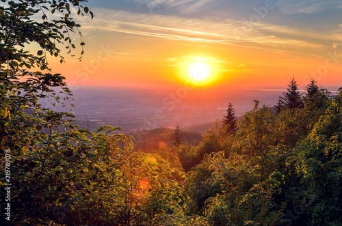 Beautiful mountain landscape. Sunset over the hills and cities. © shadowmoon30