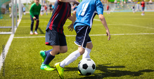 Junior Football Match Competition. Two Young Footballers Running and Competing For Ball. Youth Soccer Tournament