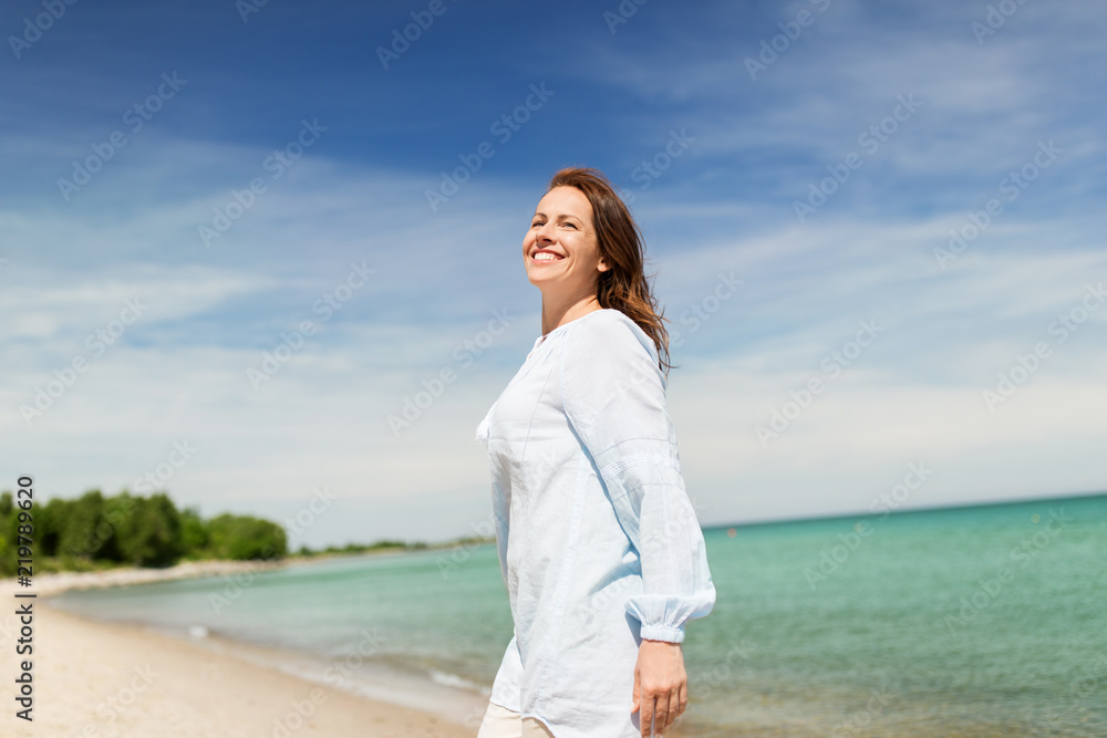 people and leisure concept - happy smiling woman on summer beach people and leisure concept - happy smiling woman on summer beach