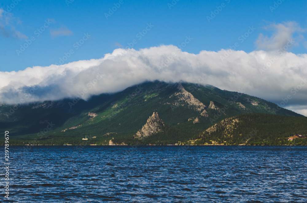 Beautiful landscape, lake, mountains in clouds and nature.