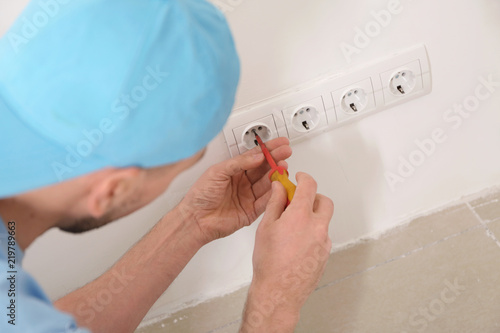 Electrician repairing socke...
