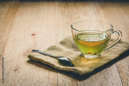 Close-up a cup of green tea on sackcloth, hot drink with steam