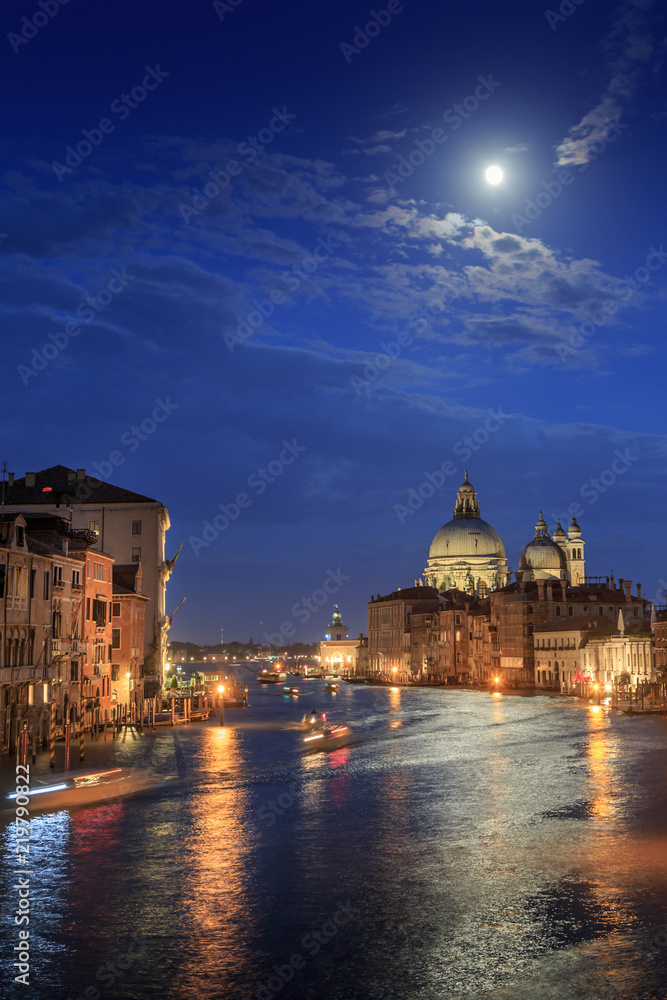 The moon shines over Venice. Picture taken from the Academy bridge. Italy.