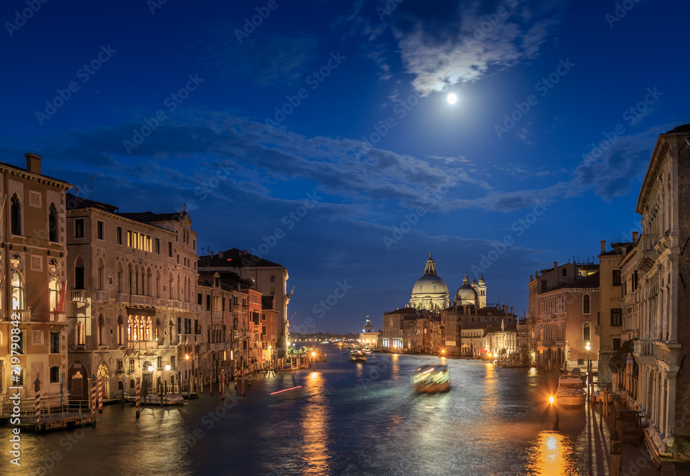 The moon shines over Venice. Picture taken from the Academy bridge. Italy.
