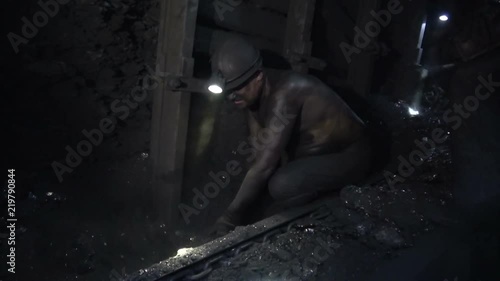 Heavy work of miners in a coal mine. Hard labour. Solid fuel