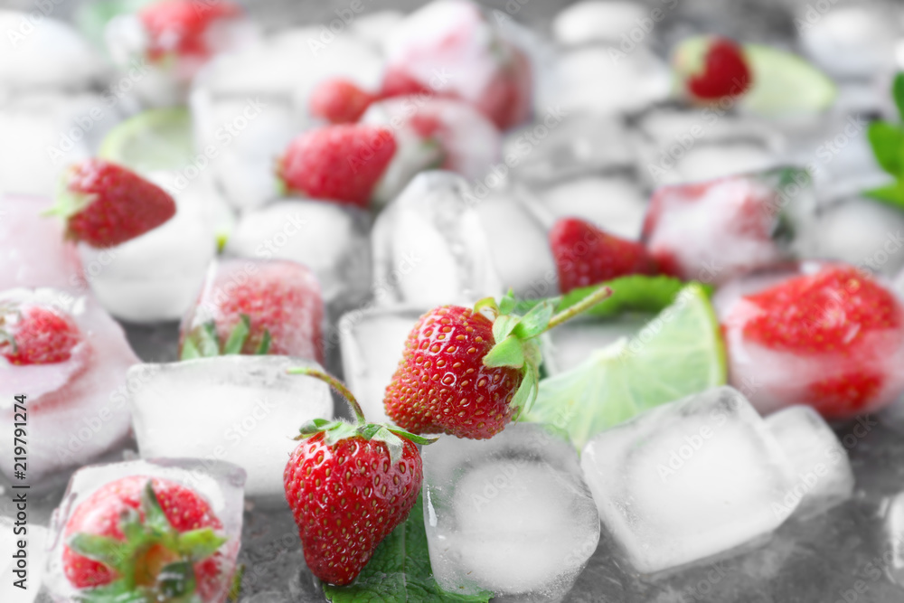 Ice cubes with strawberries on table Ice cubes with strawberries on table