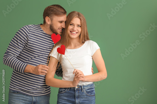 Happy young couple with red...