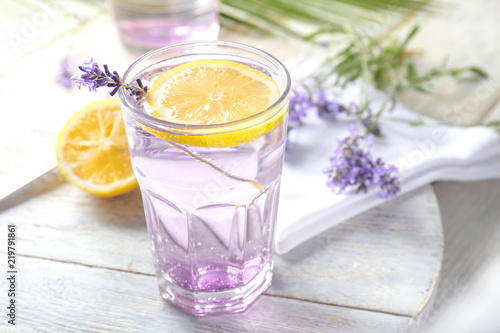 Glass with fresh lavender lemonade on table