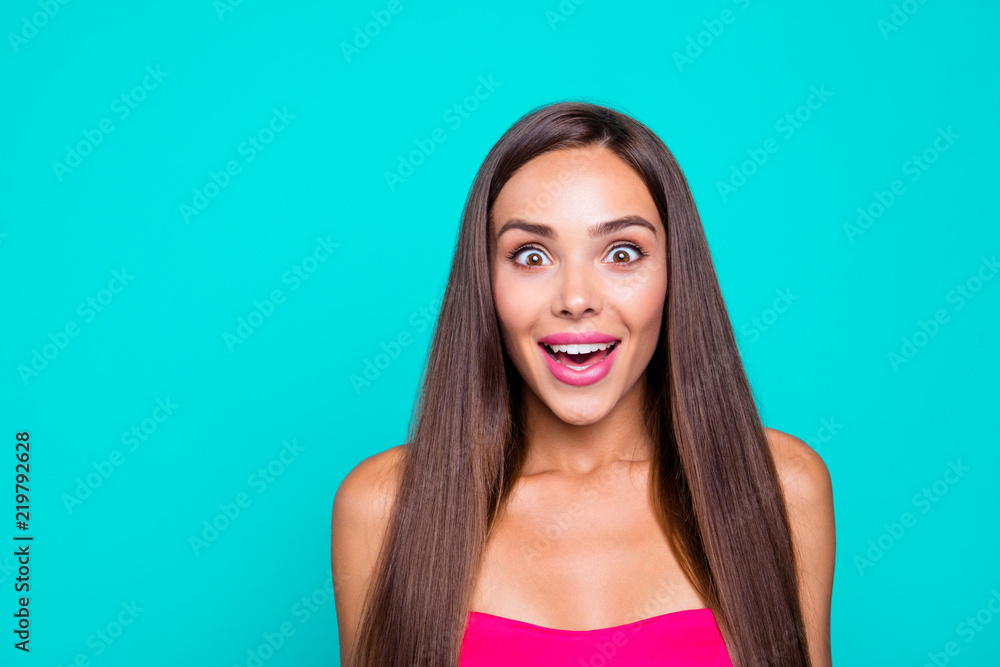 Portrait of young straight-haired brunette cheerful amazed girl wearing pink top, showing facial wow expression. Copy space. Isolated over bright vivid turquoise background Portrait of young straight-haired brunette cheerful amazed girl wearing pink top, showing facial wow expression. Copy space. Isolated over bright vivid turquoise background