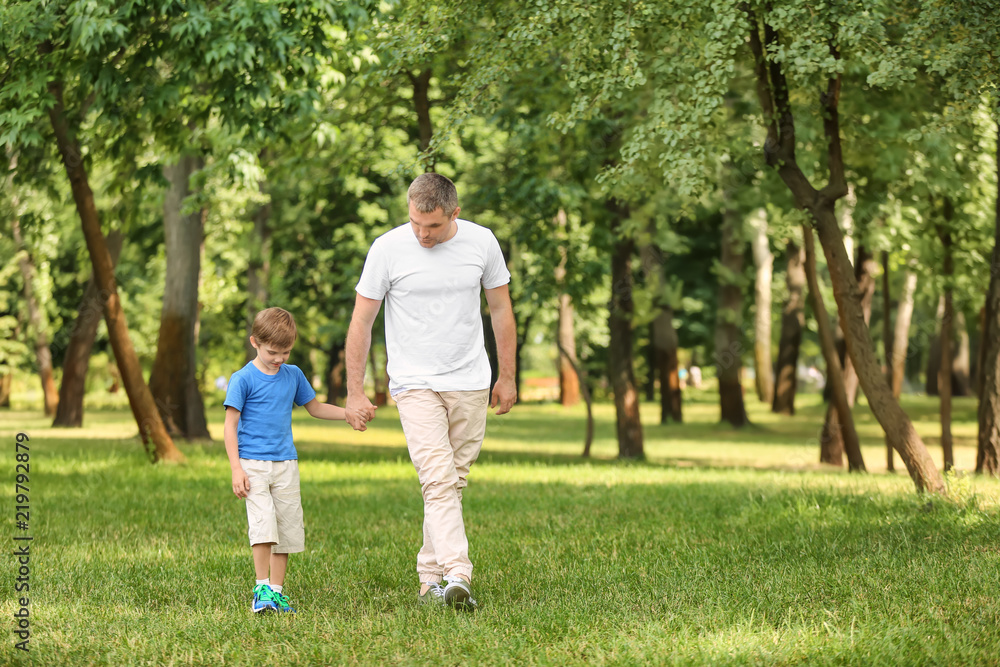 Happy father and son in green park