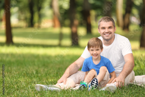Happy father with son resti...
