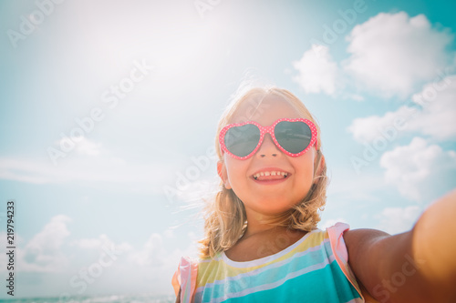selfie of cute happy little girl at beach photo