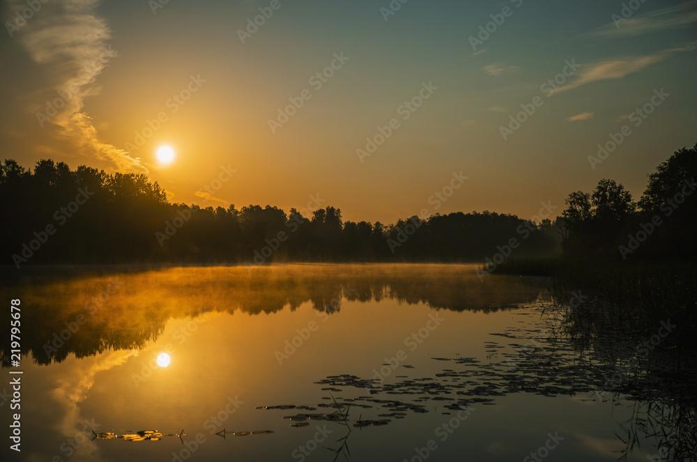Obraz premium Sunrise over calm lake, Latvia, Kurzeme