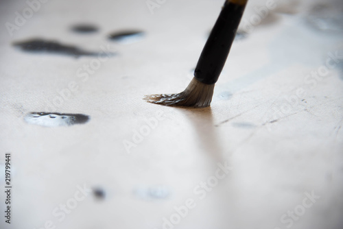 Close up on hand holding brush while writing calligraphy chinese or japanese language. photo