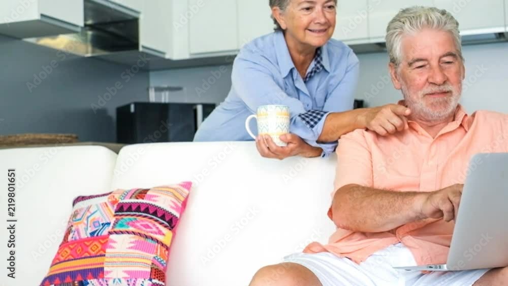 couple of adult caucasian man and woman at home stay together on the sofa enjoying the afternoon and the indoor leisure activity. everyday forever family concept. day at home and play with no limits o couple of adult caucasian man and woman at home stay together on the sofa enjoying the afternoon and the indoor leisure activity. everyday forever family concept. day at home and play with no limits o