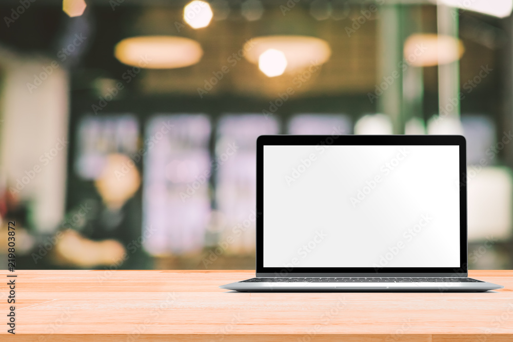Laptop with blank screen placed on white wooden table in blurred people in coffee shop or restaurant for menu or order receipt from computer Laptop with blank screen placed on white wooden table in blurred people in coffee shop or restaurant for menu or order receipt from computer