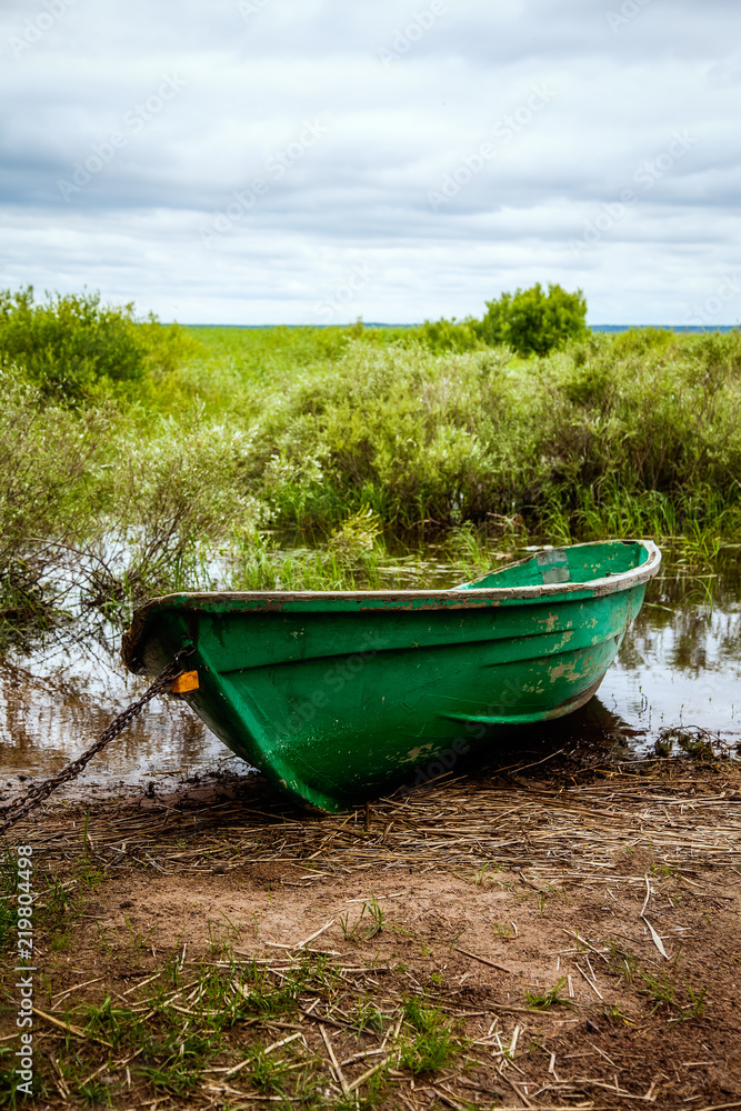Old boat is by the lake in summer Old boat is by the lake in summer