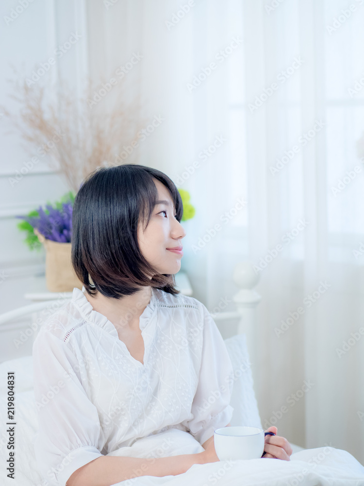 beautiful young woman drinking coffee on bed beautiful young woman drinking coffee on bed