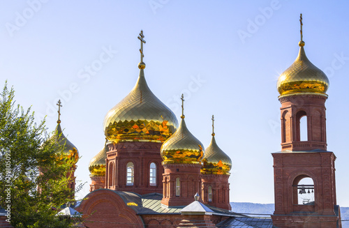 Golden domes of the temple against the blue clear sky. Christianity, religion