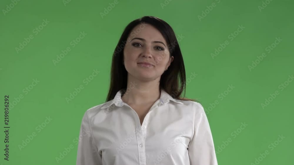 Business woman in white shirt posing against a green screen Business woman in white shirt posing against a green screen