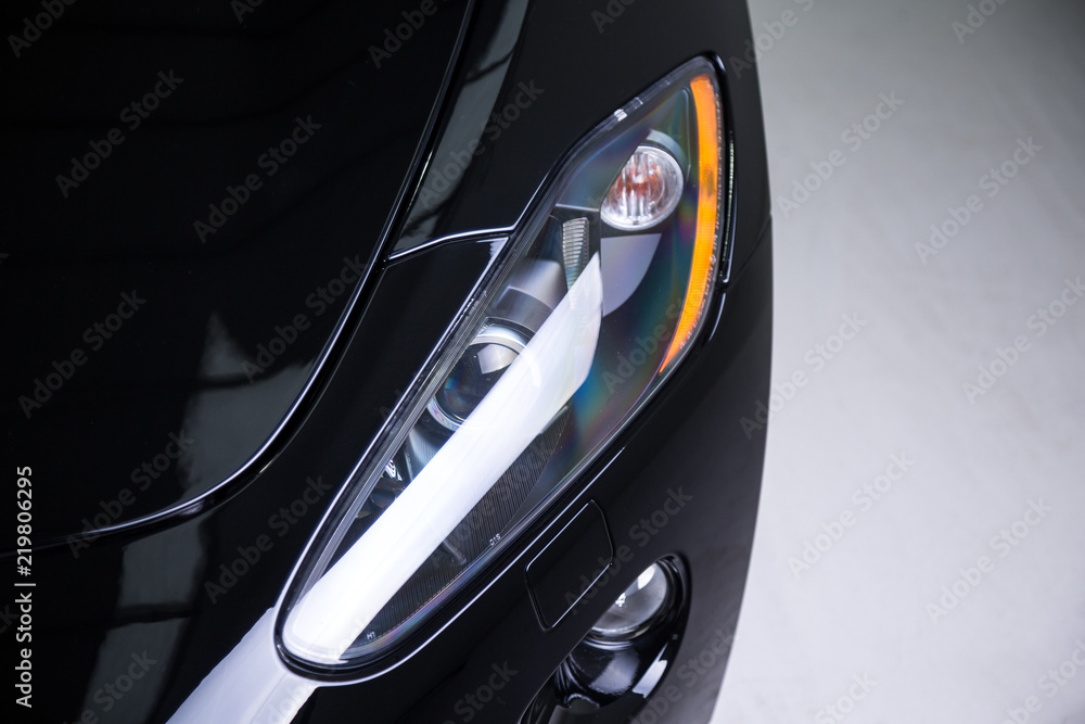 Close up of headlight on black sports car