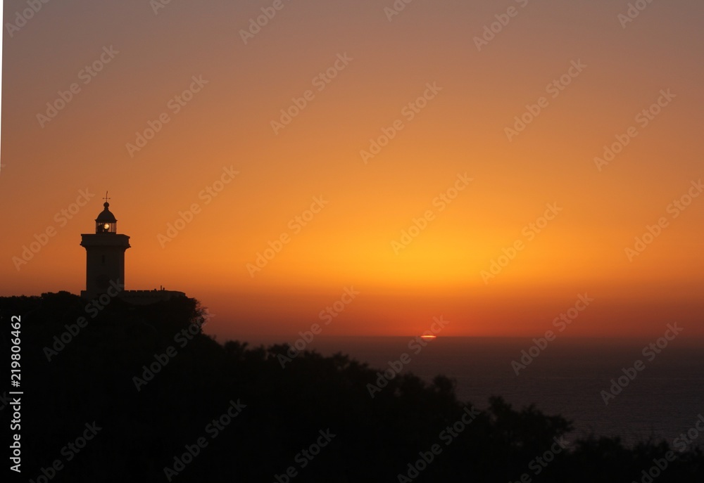 Ancient lighthouse during the last moments of sunset.  It has been built in 1924 and overlooks the detroit of Gibraltar in the Mediterranean sea from Tangier, Morocco.