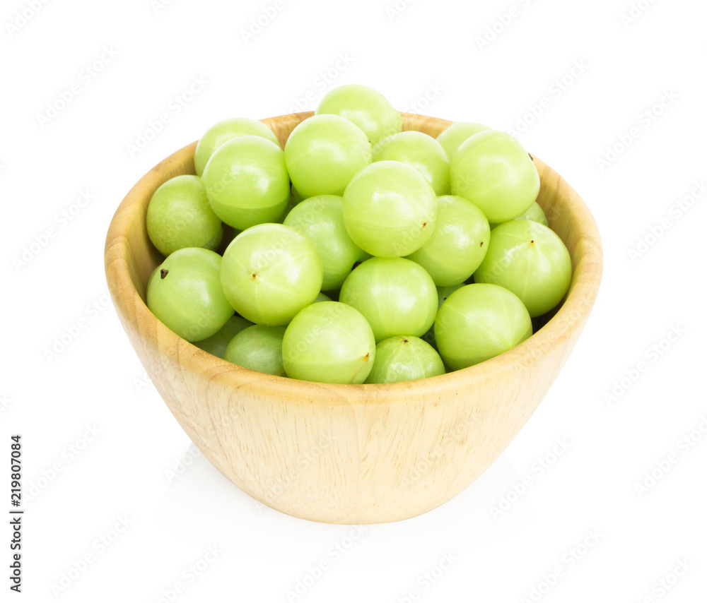 Fresh indian gooseberry in wooded bowl isolated on white background, herb and medical fruit for health care concept Fresh indian gooseberry in wooded bowl isolated on white background, herb and medical fruit for health care concept