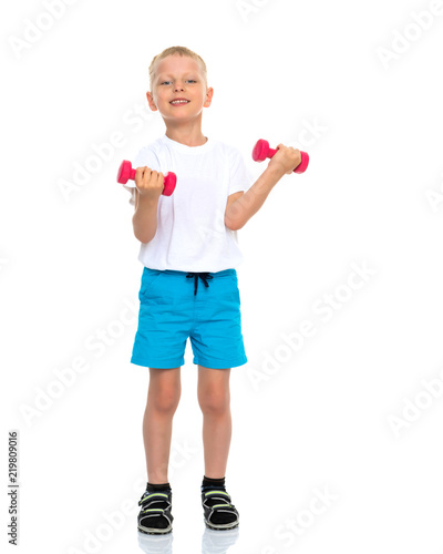 A little boy is lifting dumbbells.