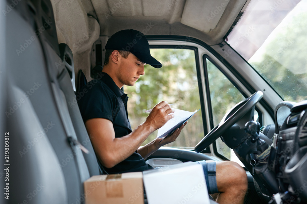 Delivery Courier In Car With Boxes. Man Delivering Packaging Delivery Courier In Car With Boxes. Man Delivering Packaging