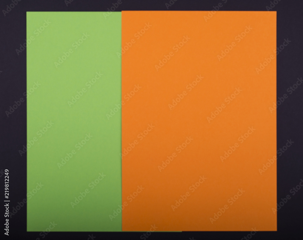 Handcraft paper background with orange, green, black paper. Place for your text. Unfocused view