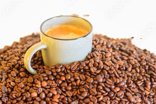 a cup of coffee on a background of coffee beans