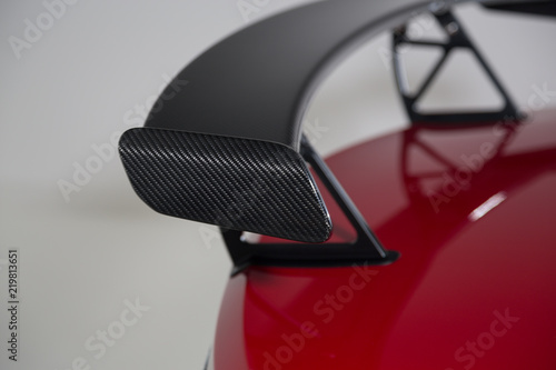 Close up of carbon fibre spoiler on red sports car