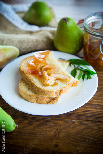pieces of bread with sweet home-made fruit jam from pears and apples in a plate