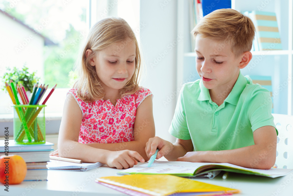Schoolchildren are came back to school and learning at the table in classroom Schoolchildren are came back to school and learning at the table in classroom
