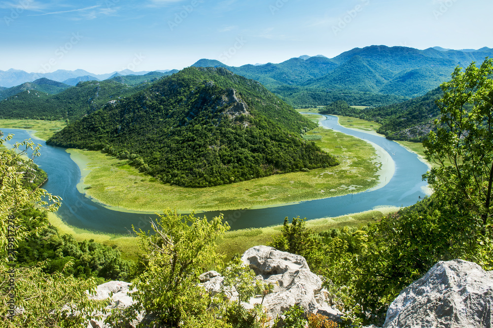 The horseshoe bend of the Rijeka Crnojevica River in Montenegro. This view is one of the most spectacular views in Montenegro and taken just before the river enters the Skada Lake - obrazy, fototapety, plakaty 