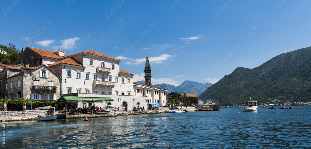 The bell tower of St Nicholas Church and the village of Perast in Montenegro. Perast is a beautiful village that sits on the bay of Kotor on the adriatic sea.