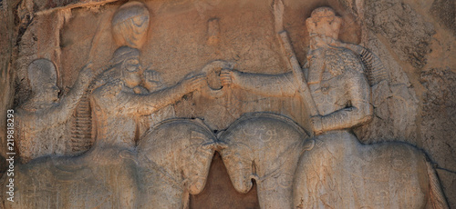 Detail of a stone decoration in a tomb ruin of the ancient necropolis Naqsh-e Rostam, that shows the triumph of Shapur over the Roman Emperor Valer. Iran photo