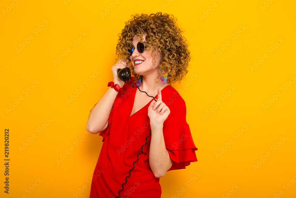 Attractive woman with short curly hair with phone Attractive woman with short curly hair with phone