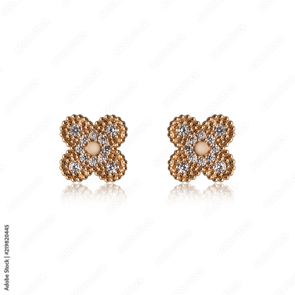 Pair of golden diamond earrings isolated on white Pair of golden diamond earrings isolated on white