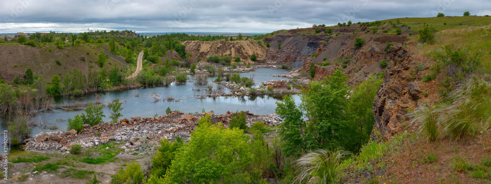 The beautiful scenery of abandoned sandstone quarry with the lake on the bottom The beautiful scenery of abandoned sandstone quarry with the lake on the bottom