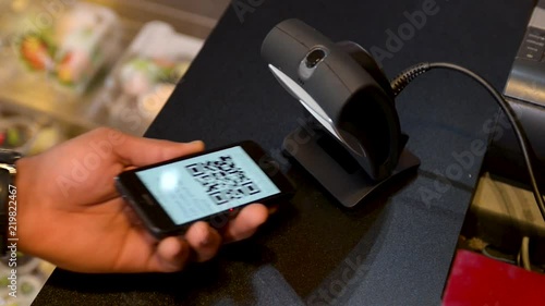 Person Using Phone to Pay at Sushi Restaurant