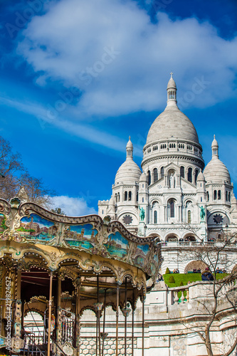 Carrousel and the Sacre Coeur Basilica at the Montmartre hill in Paris France