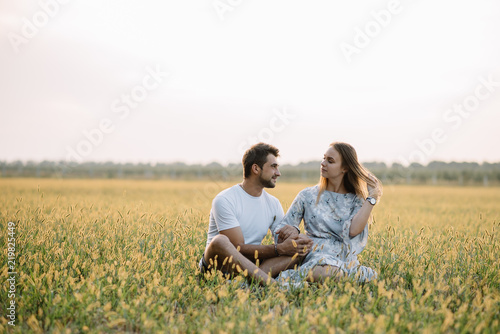 A girl and a guy are walking in the park. Portrait of a couple, a love story. Happy smiling, loveling couple together outstretched at beautiful nature. Lovestory photo