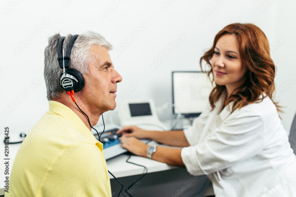 Senior man at medical examination or checkup in otolaryngologist's office Senior man at medical examination or checkup in otolaryngologist's office