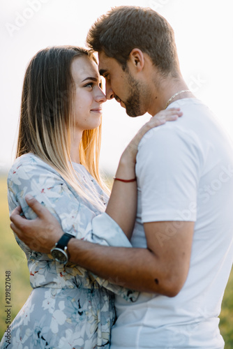 A girl and a guy are walking in the park. Portrait of a couple, a love story. Happy smiling, loveling couple together outstretched at beautiful nature. Lovestory photo