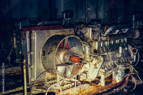 Old rusty diesel generator of air filtration and ventilation system in abandoned Soviet bunker