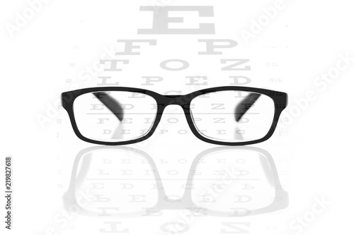 Clear black modern glasses on a eye sight test chart. Isolated