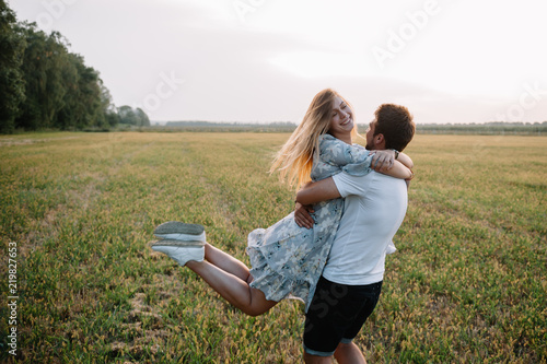 A girl and a guy are walking in the park. Portrait of a couple, a love story. Happy smiling, loveling couple together outstretched at beautiful nature. Lovestory photo