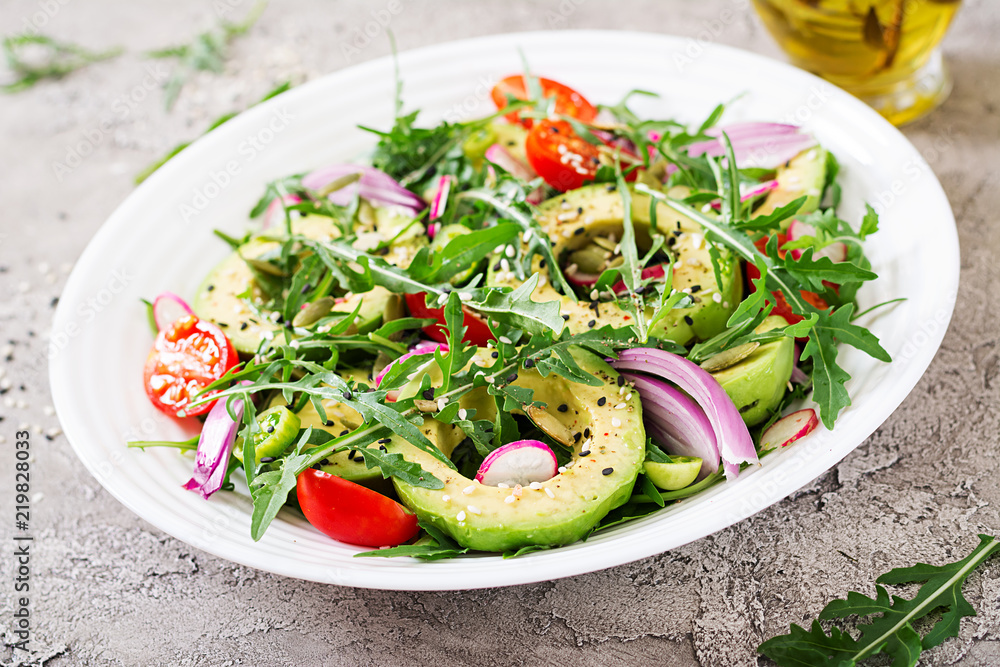 Diet menu. Healthy salad of fresh vegetables - tomatoes, avocado, arugula, radish and seeds on a bowl. Vegan food. Diet menu. Healthy salad of fresh vegetables - tomatoes, avocado, arugula, radish and seeds on a bowl. Vegan food.