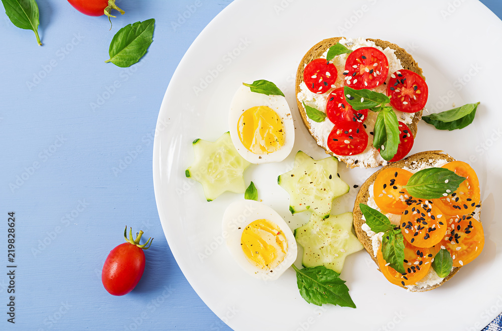 Breakfast. Sandwich with cream cheese with tomatoes and cream cheese. Top view. Flat lay Breakfast. Sandwich with cream cheese with tomatoes and cream cheese. Top view. Flat lay